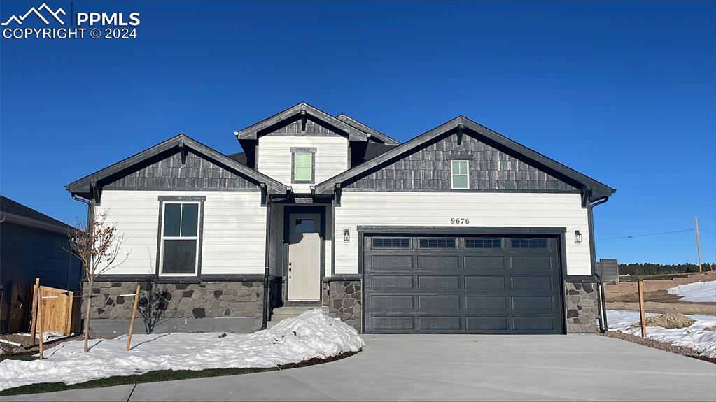 Craftsman-style home featuring a garage