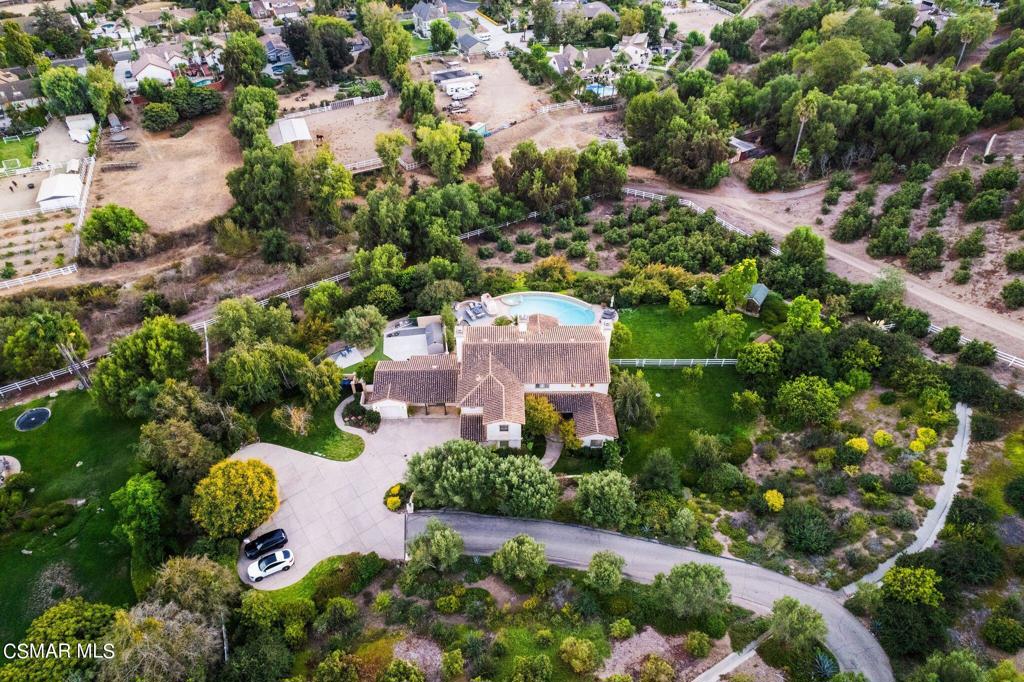 an aerial view of a house with a yard and lake view