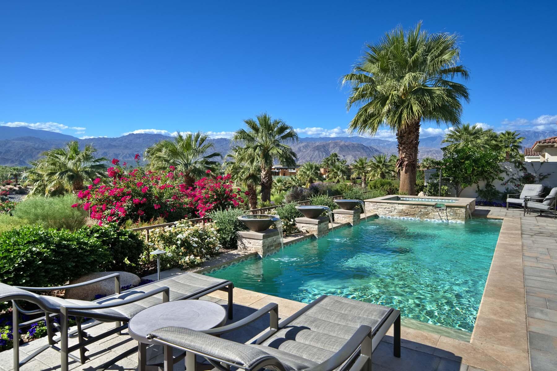 a view of a backyard with plants and lake view