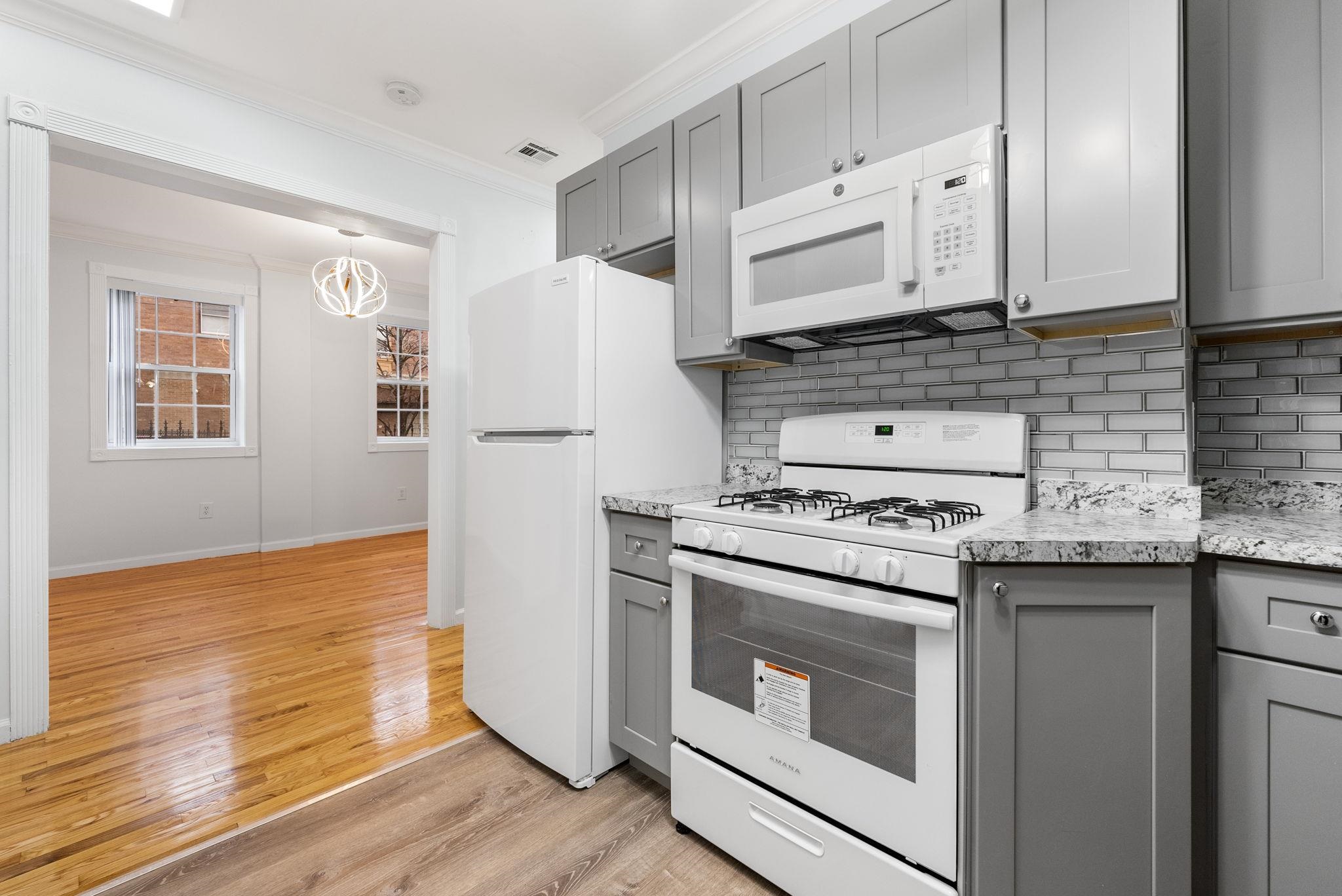 a kitchen with a stove a sink and a refrigerator