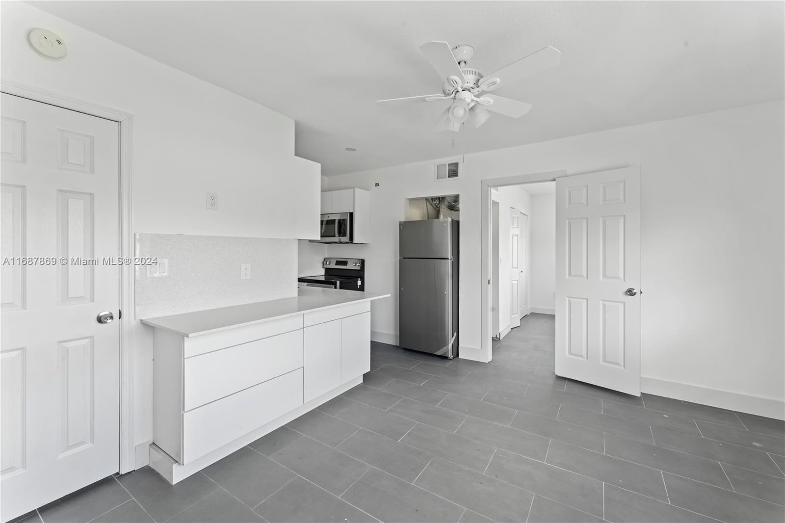 a kitchen with refrigerator cabinets and electronic appliances