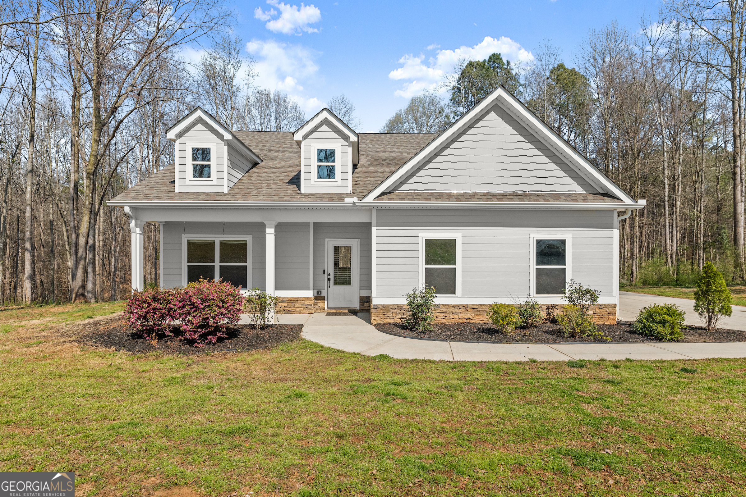 a front view of house with yard outdoor seating and barbeque oven