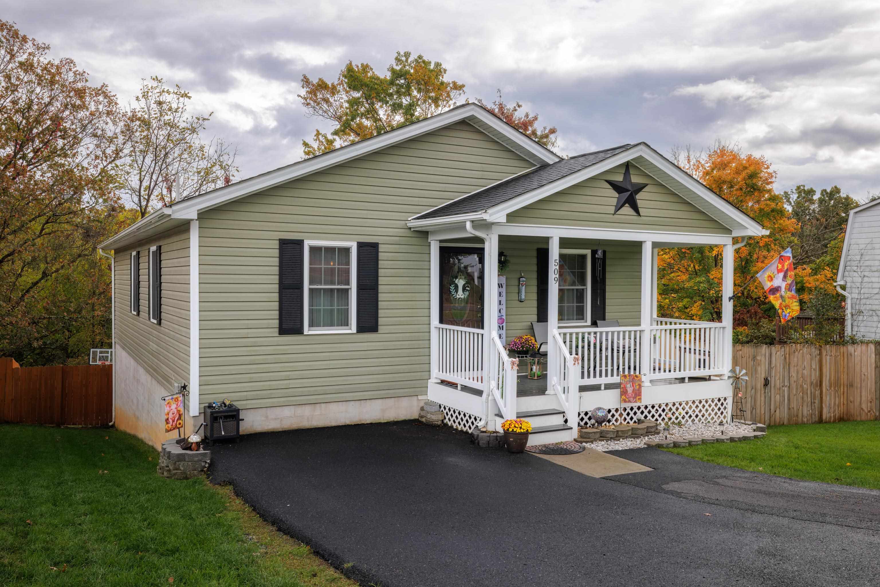 a front view of a house with a garden and yard