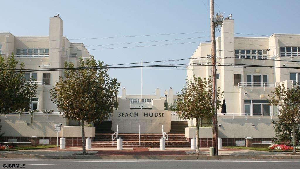 a view of a tall building next to a road