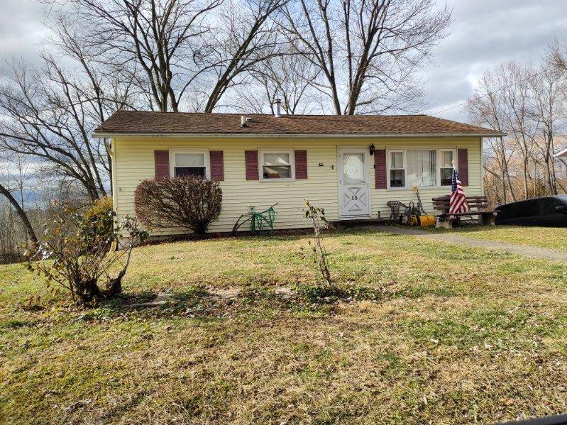 a front view of a house with a yard and porch