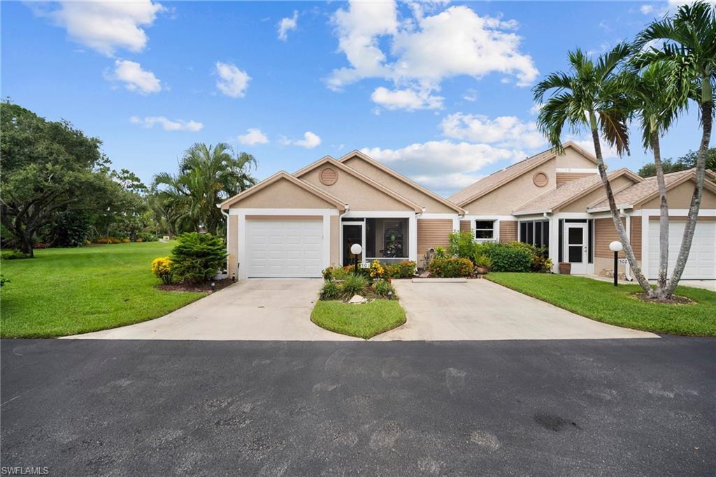 a front view of a house with yard and garage