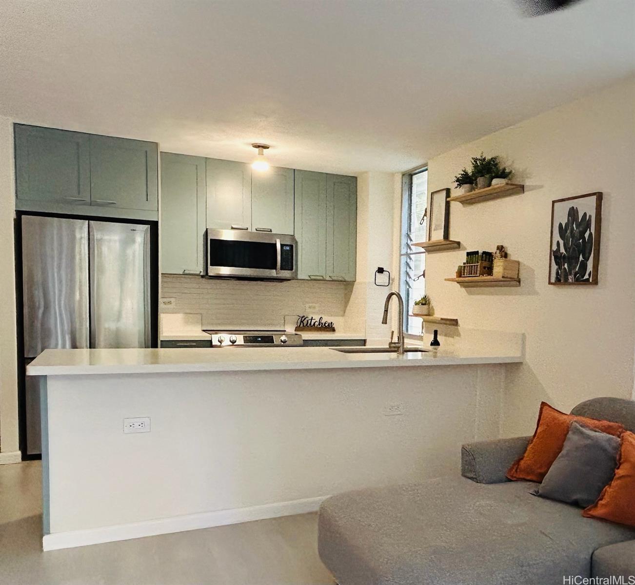 a kitchen with stainless steel appliances granite countertop a sink and a refrigerator