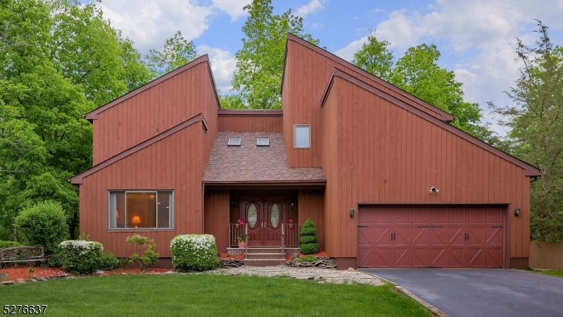 a view of a house with brick walls and a yard with plants