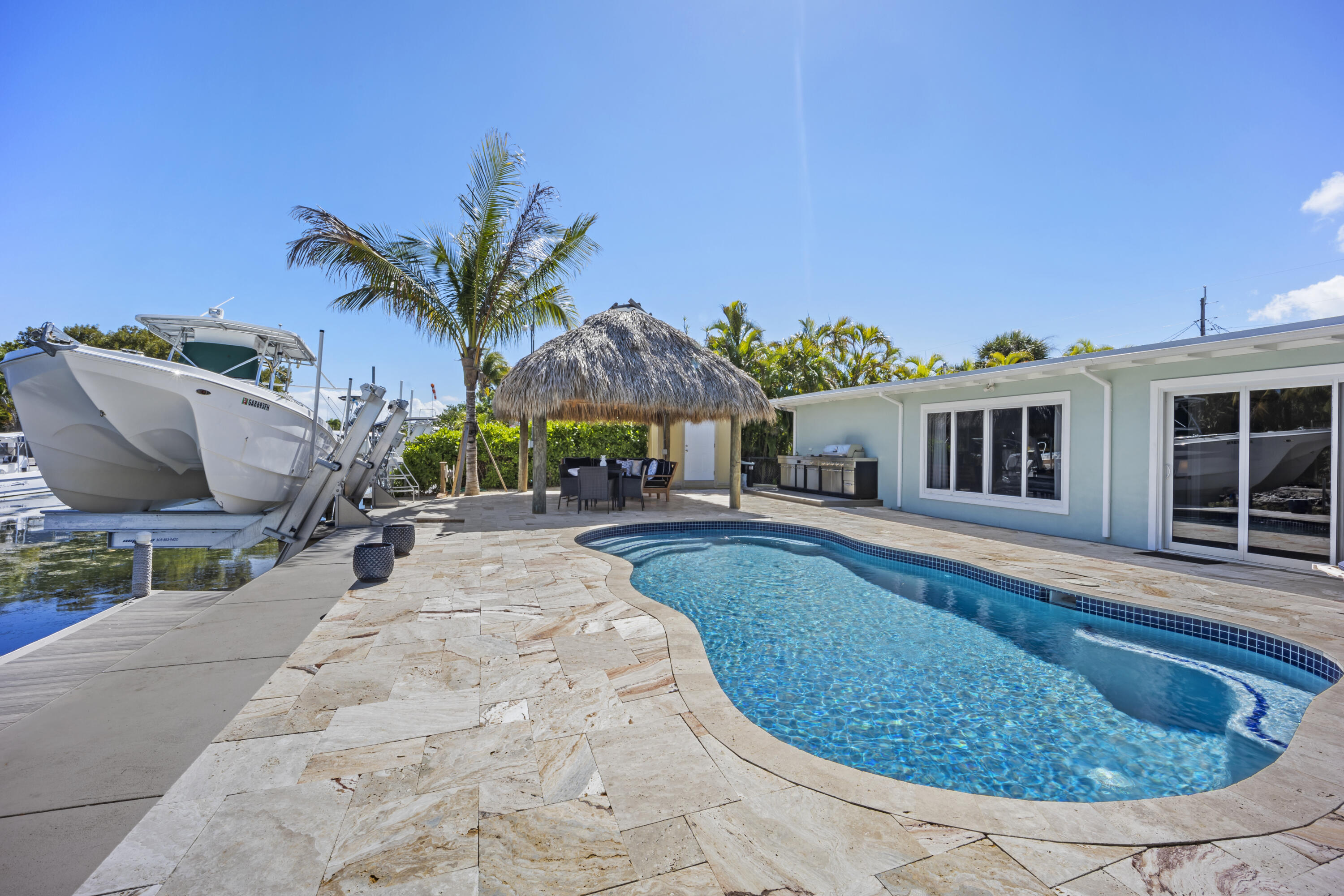 a view of a house with swimming pool and sitting area