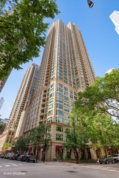 a view of a tall building next to a road