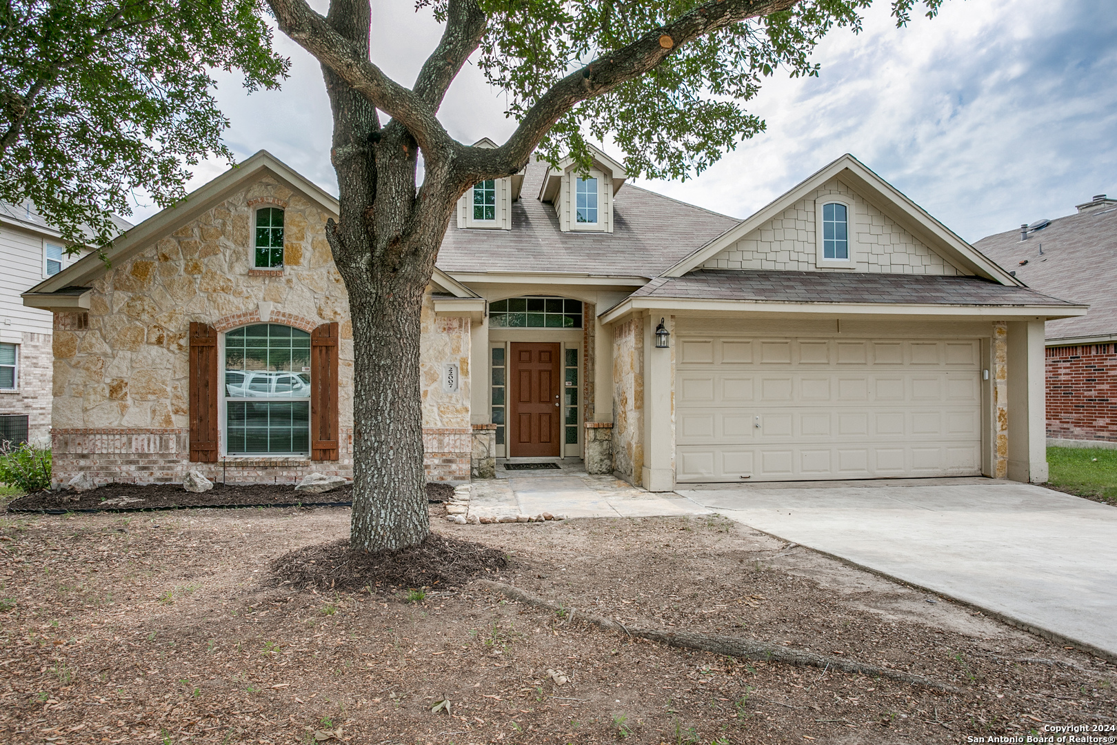 a front view of a house with a yard and garage