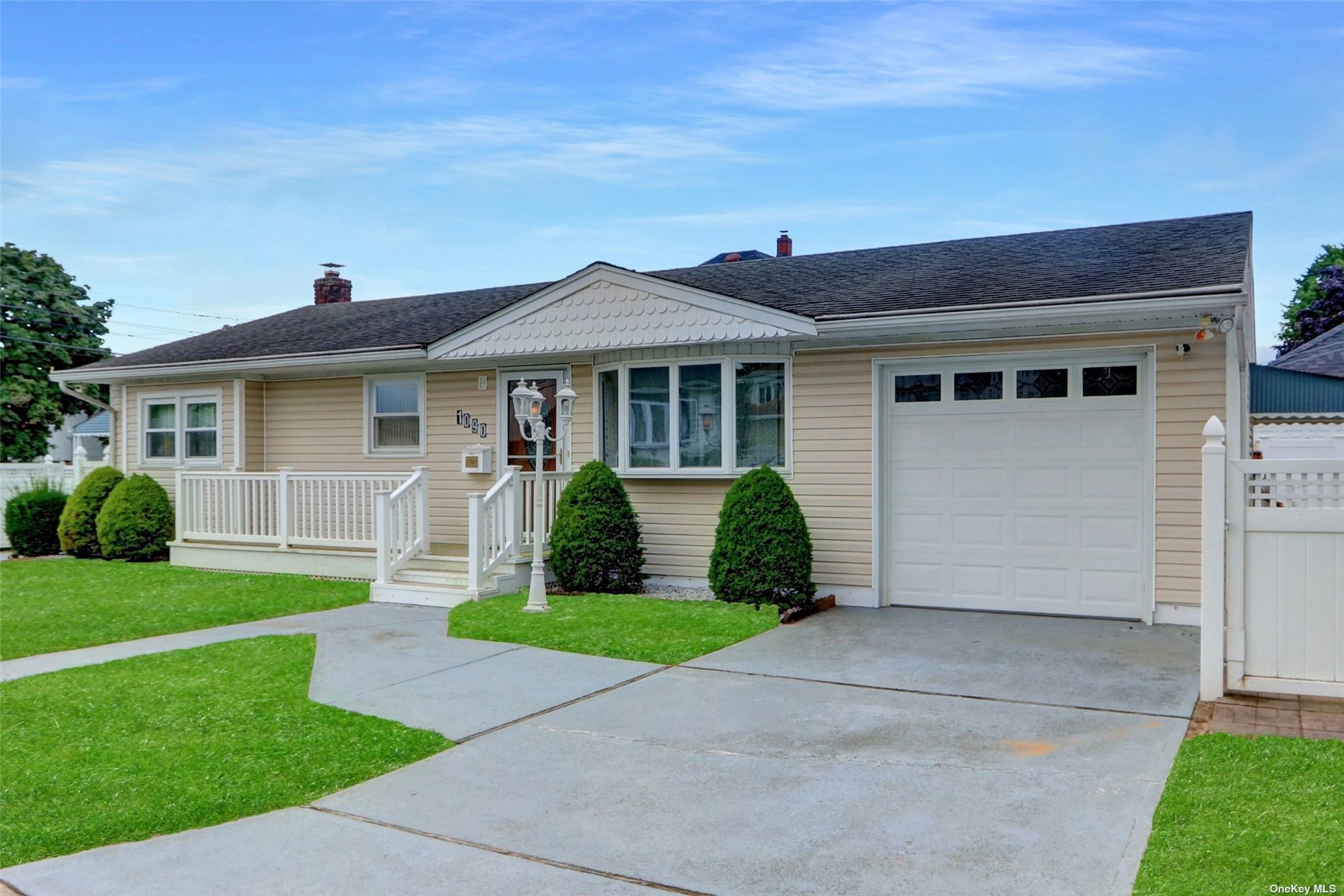 a view of a house with a yard and plants