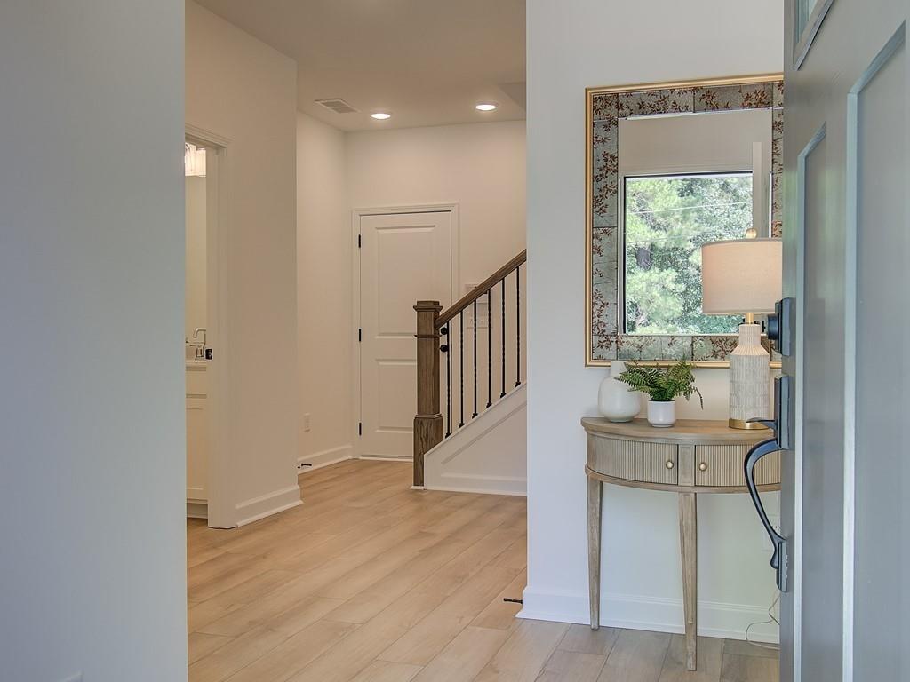 a hallway with a large window and a couch