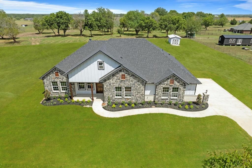 a aerial view of a house with a big yard