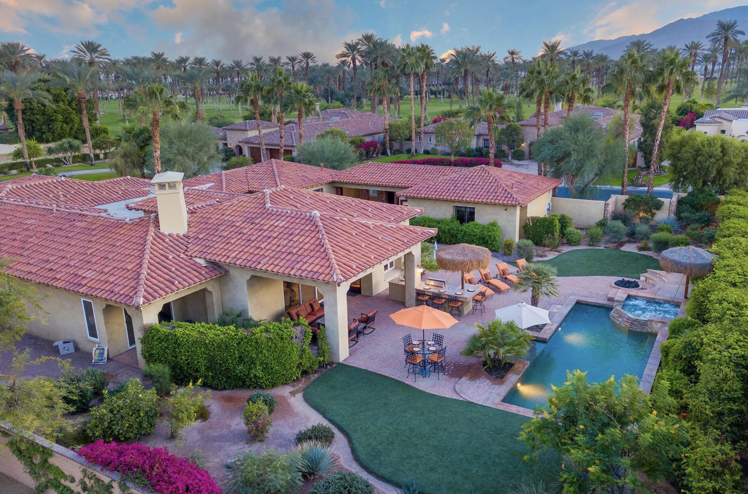 an aerial view of a house with garden space and street view