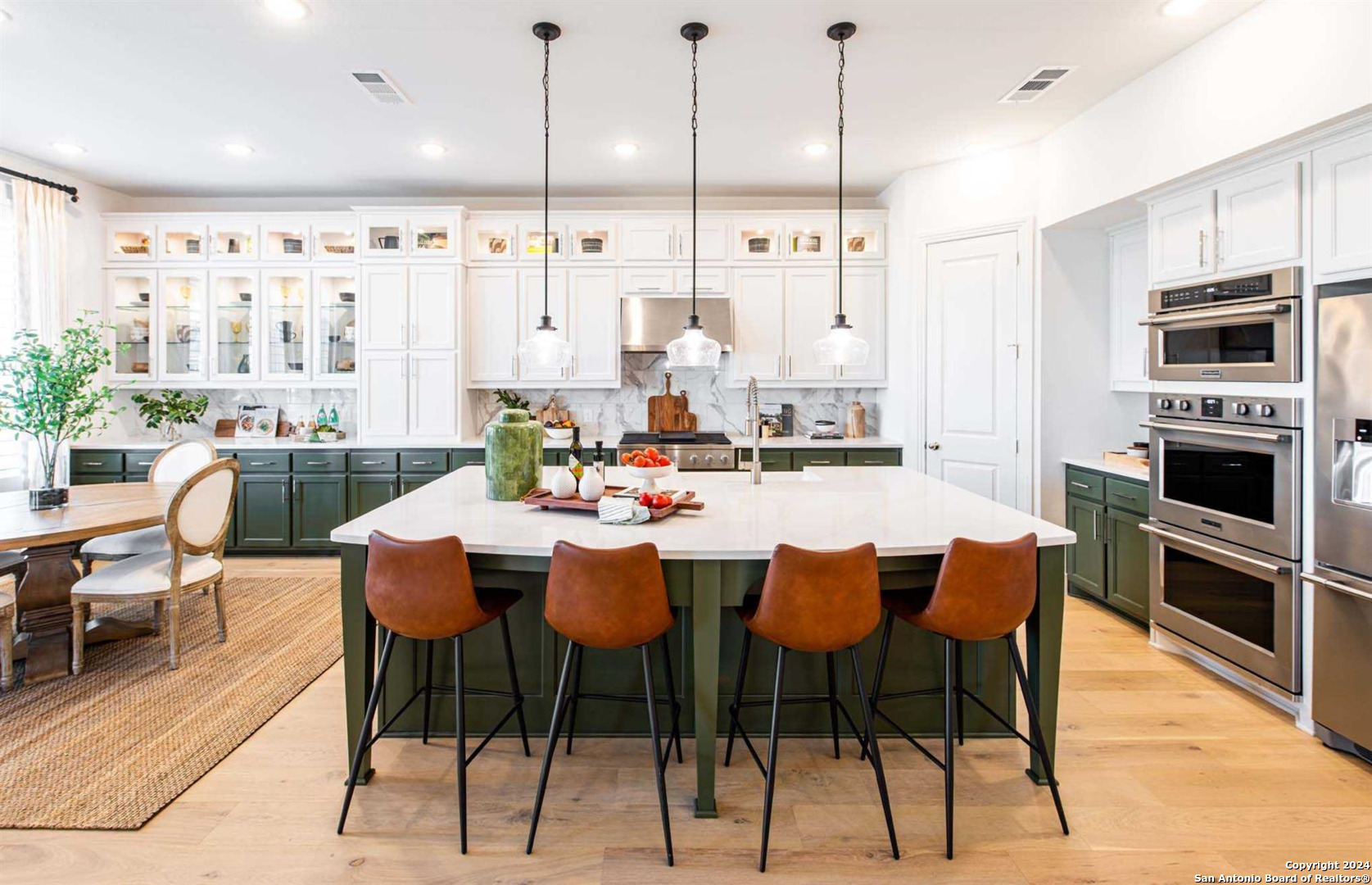 a dining table chairs and a kitchen view