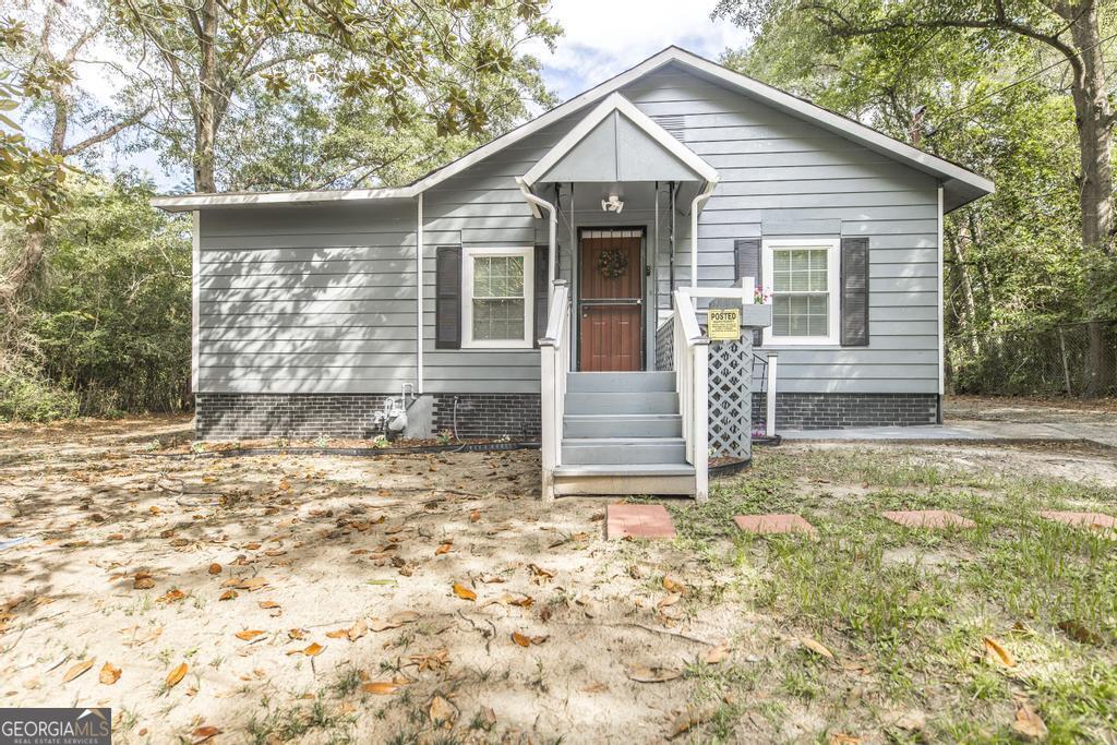 a front view of a house with garden