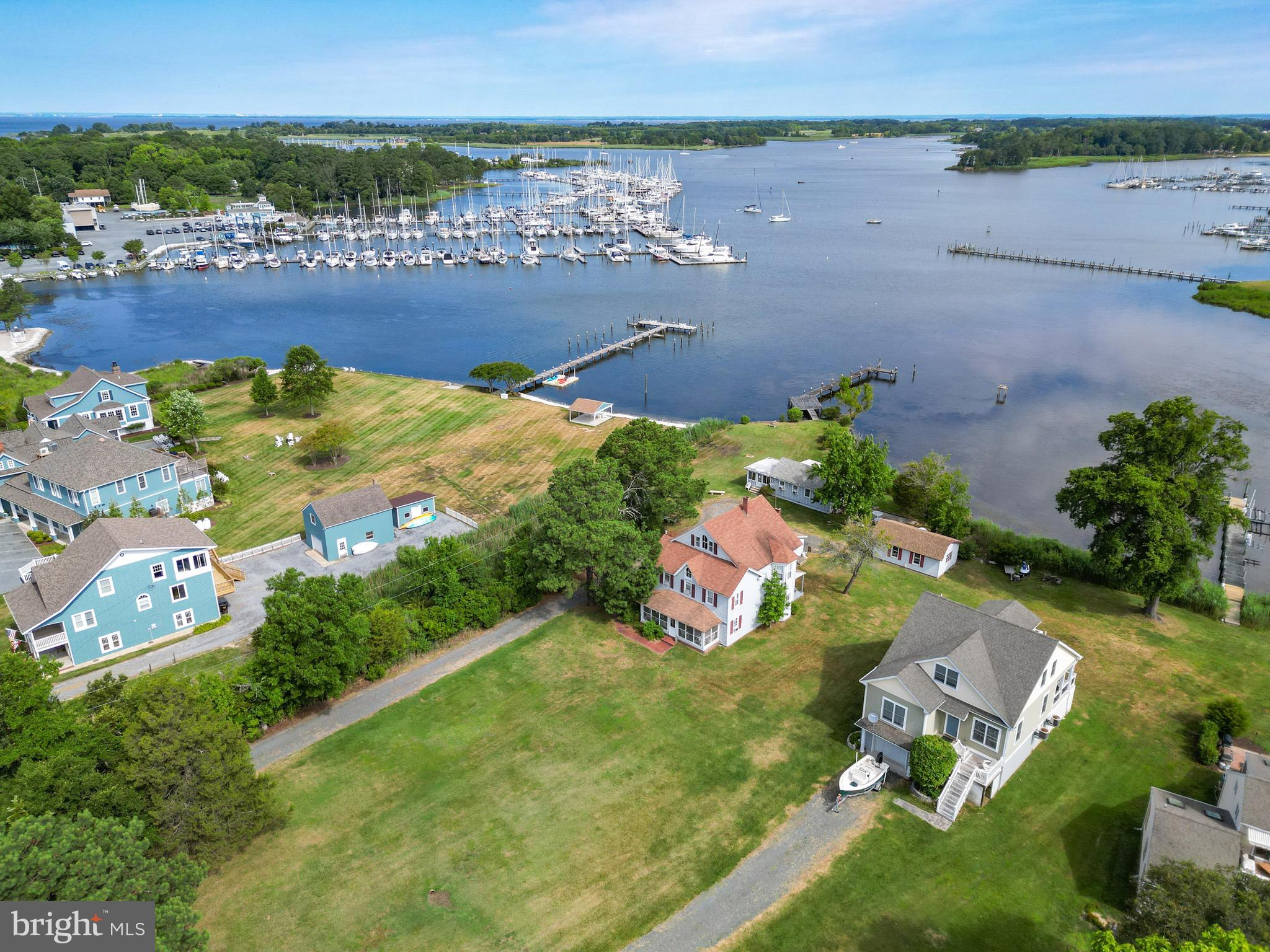 an aerial view of a house with a garden and lake view