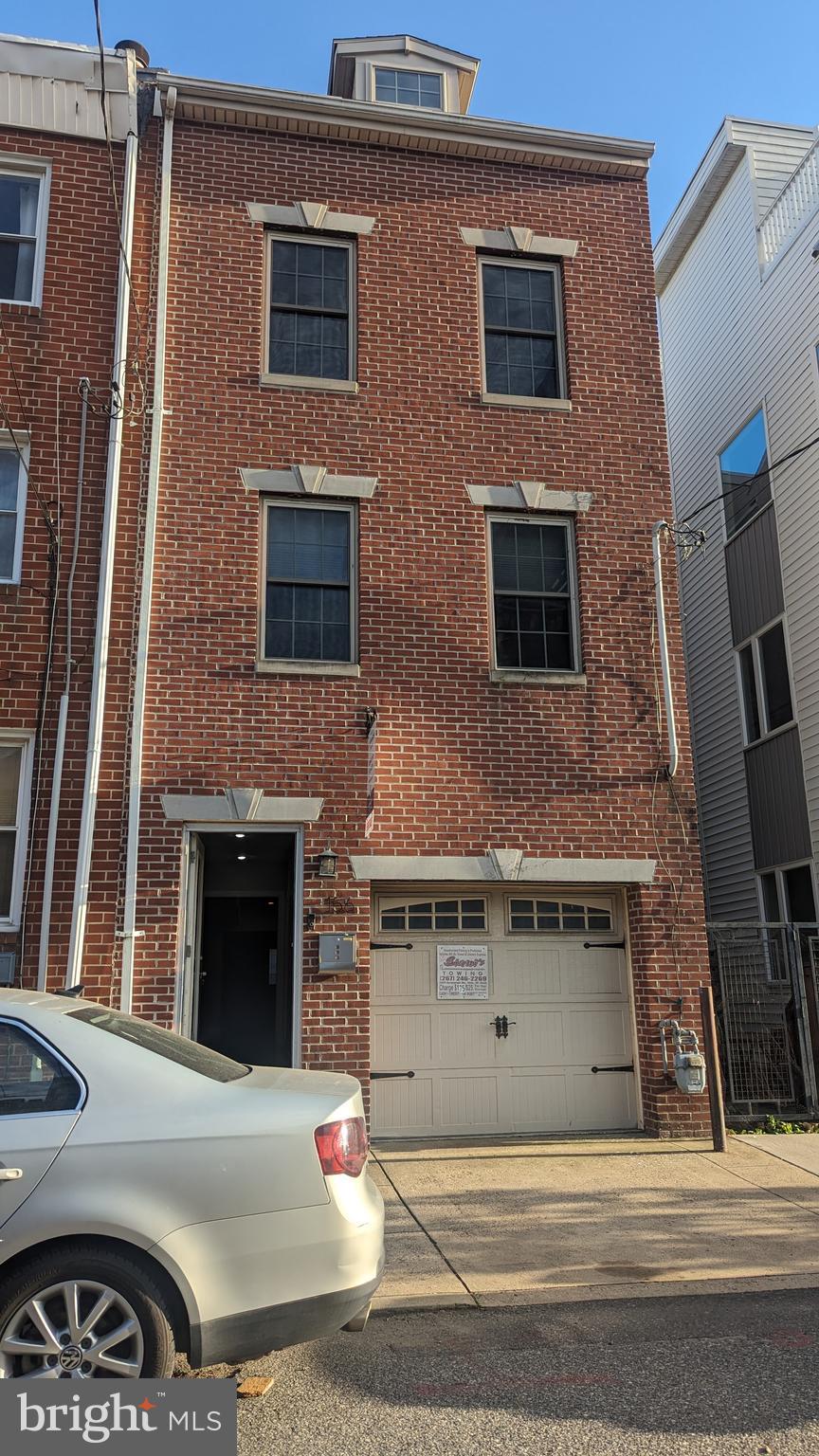 a front view of a house with parking space