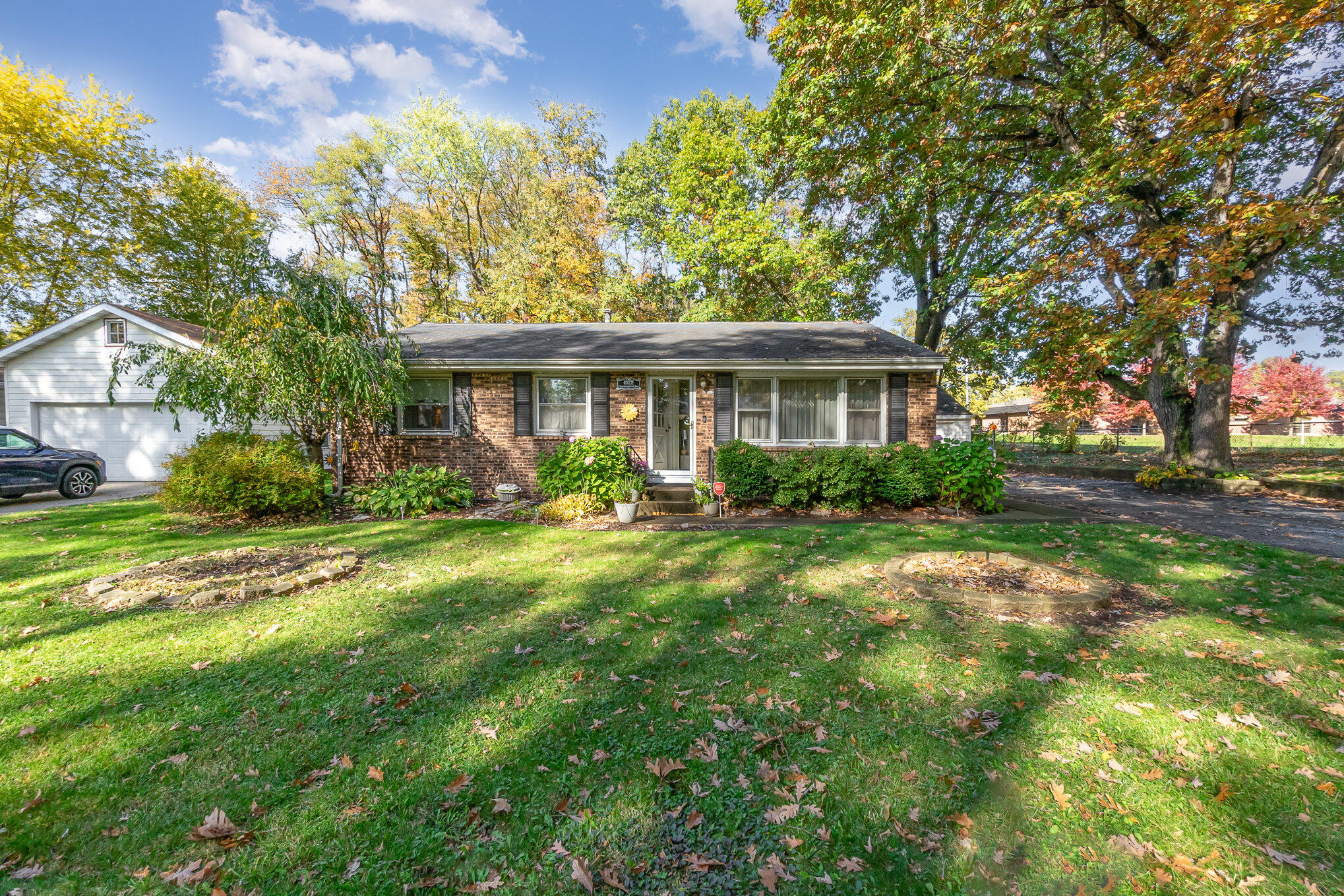 a front view of house with yard and green space