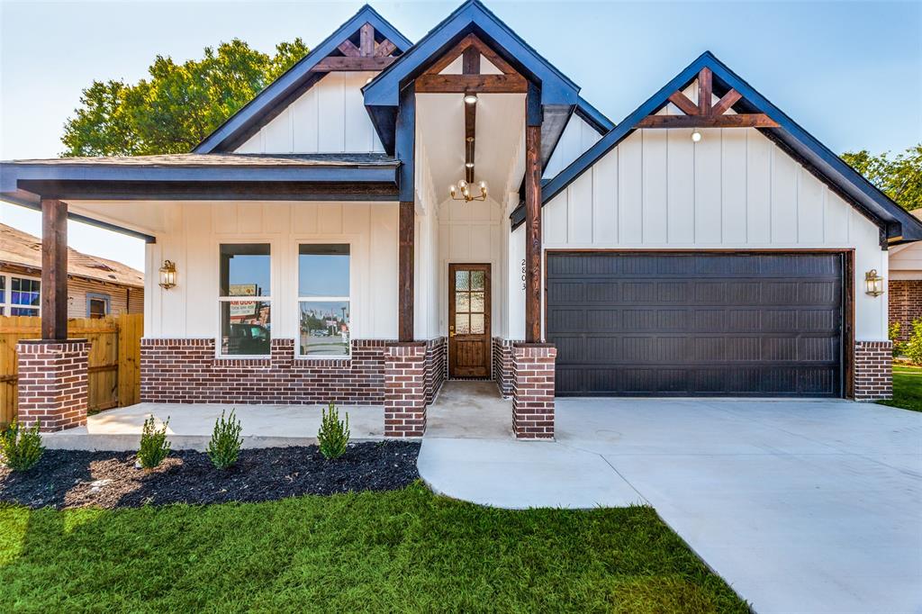 a front view of a house with a yard and outdoor seating