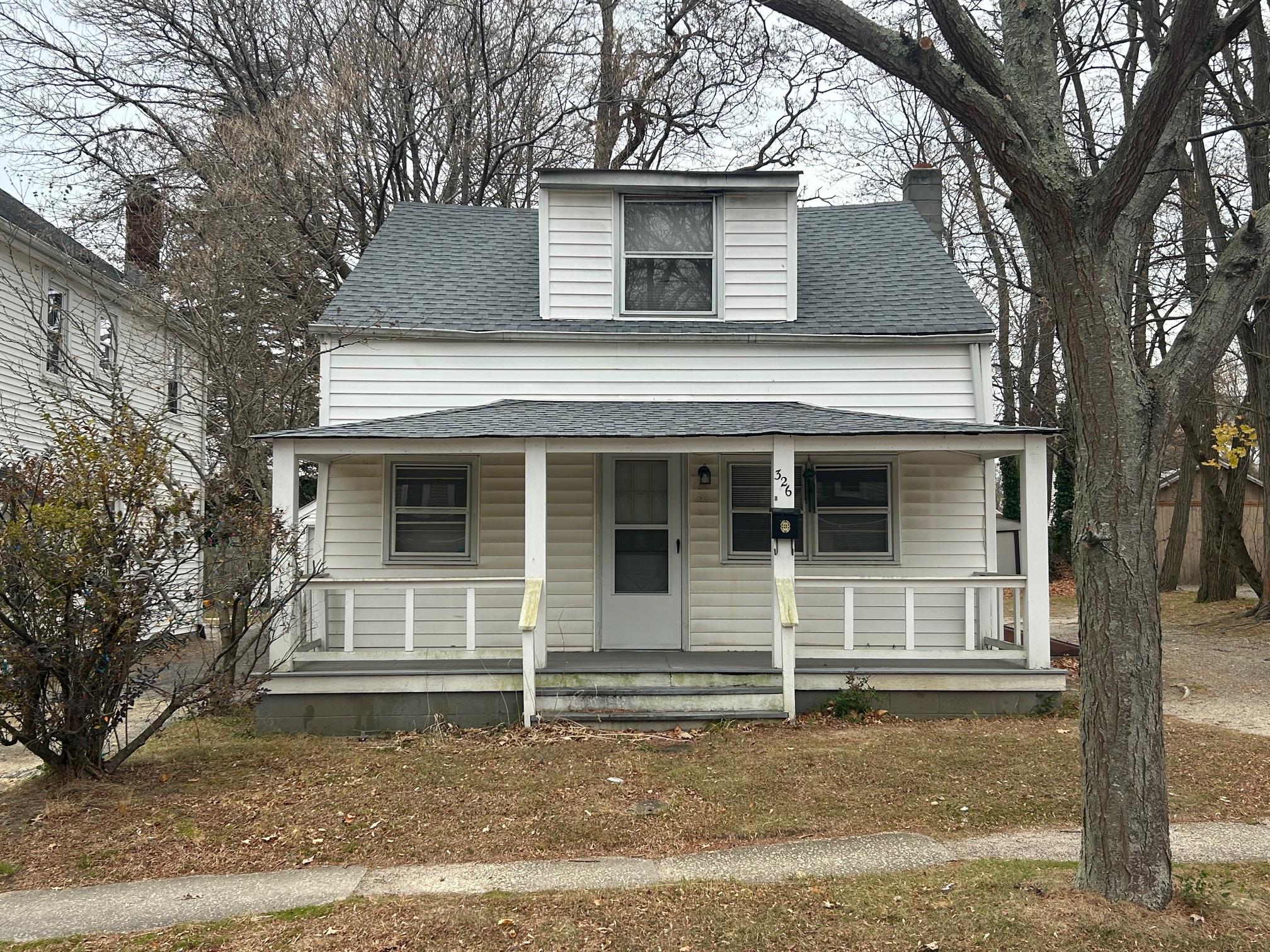 a view of a house with a large tree