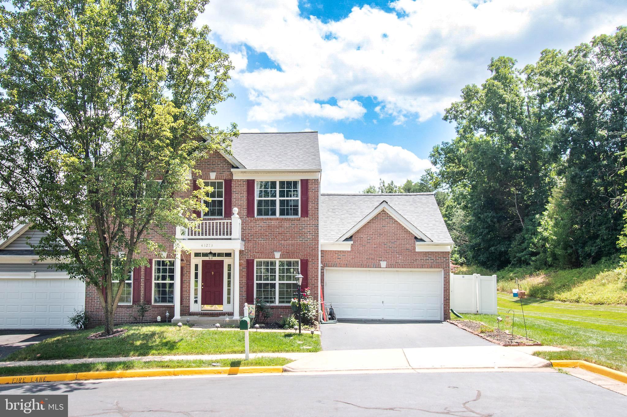 a view of house with outdoor space and parking