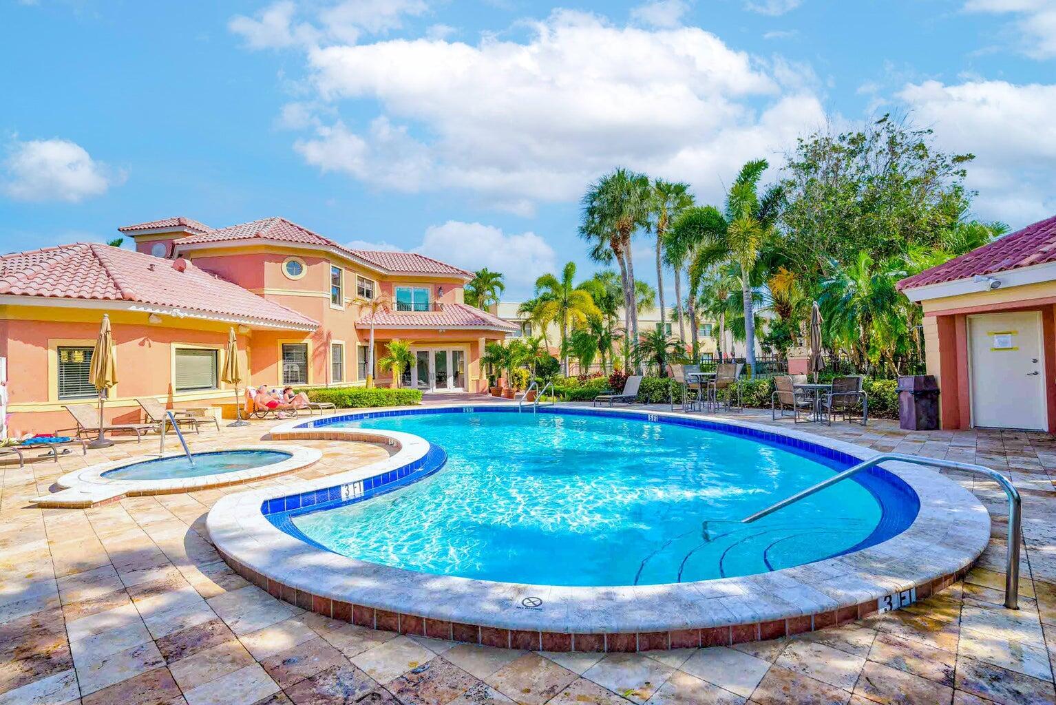 a view of a house with swimming pool and sitting area