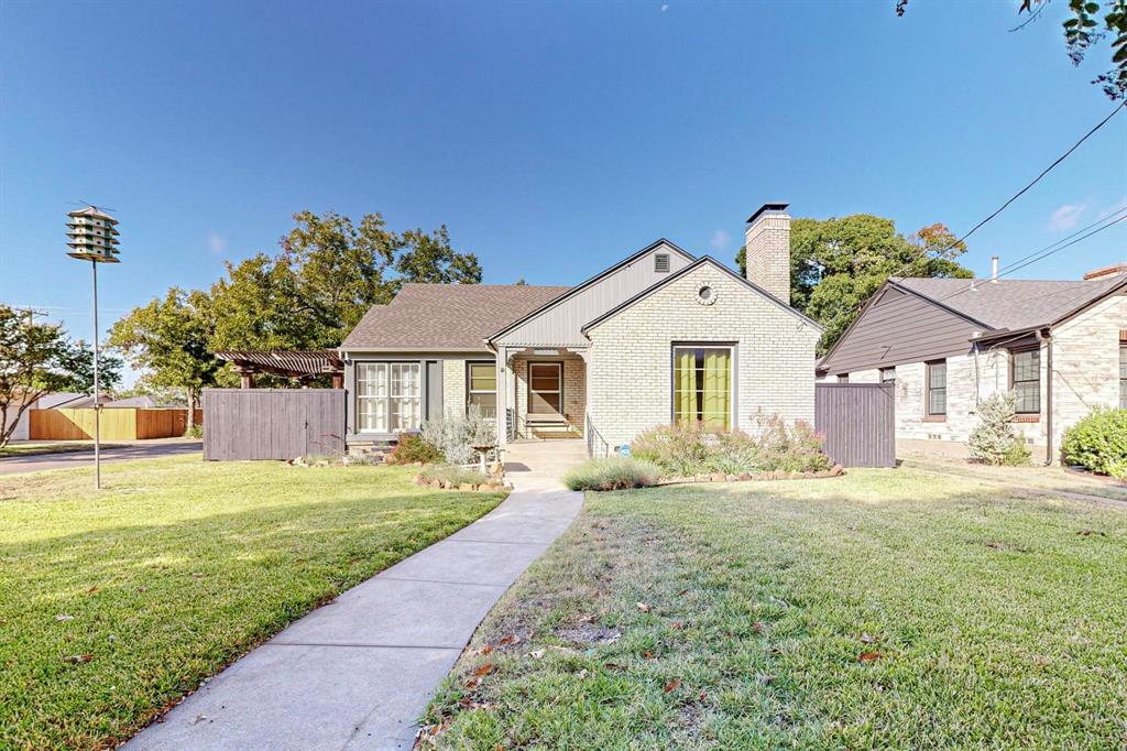 a front view of a house with a garden and yard