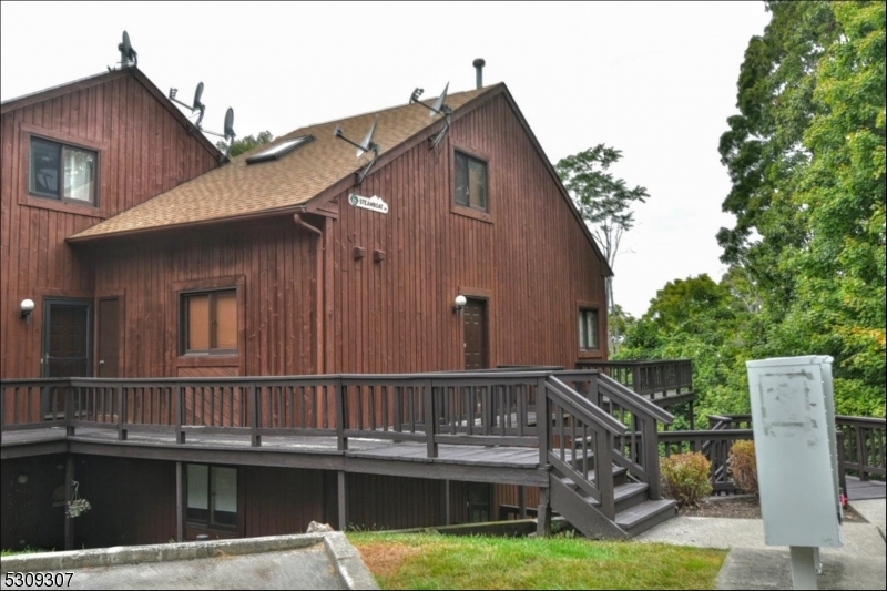 a view of a house with wooden deck