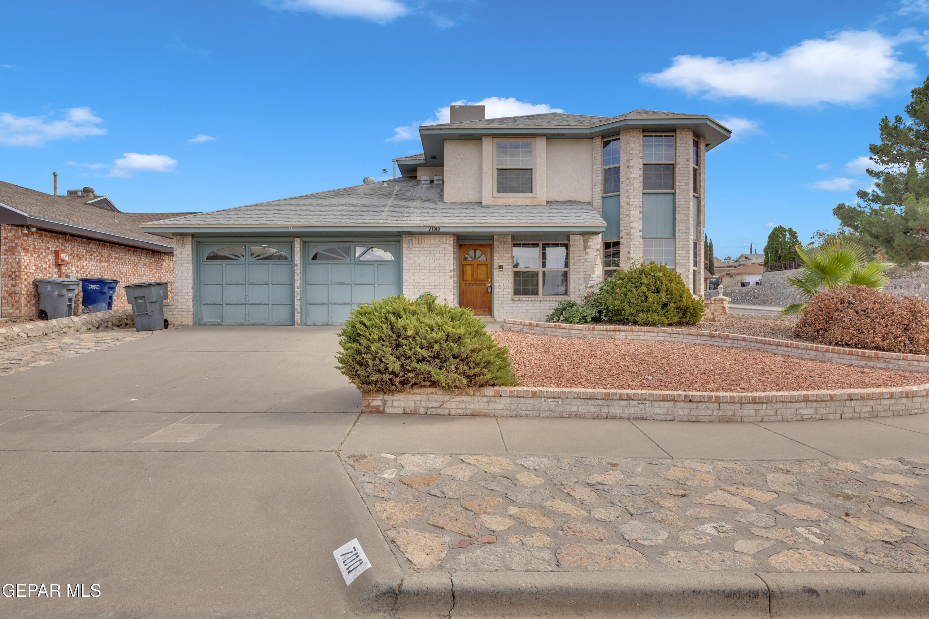 a front view of a house with a yard and a garage