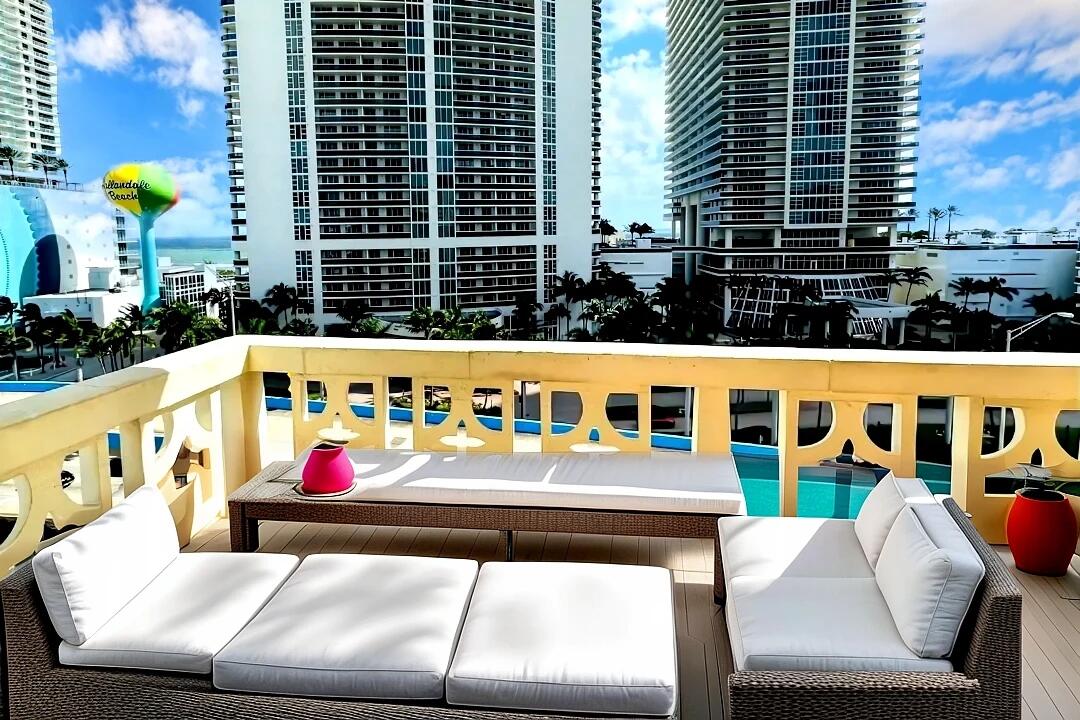 a view of a balcony with outdoor seating