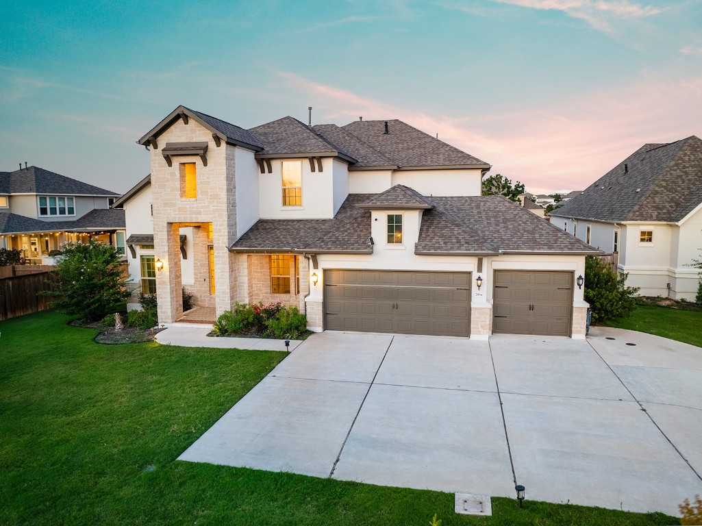 a front view of a house with a yard and garage