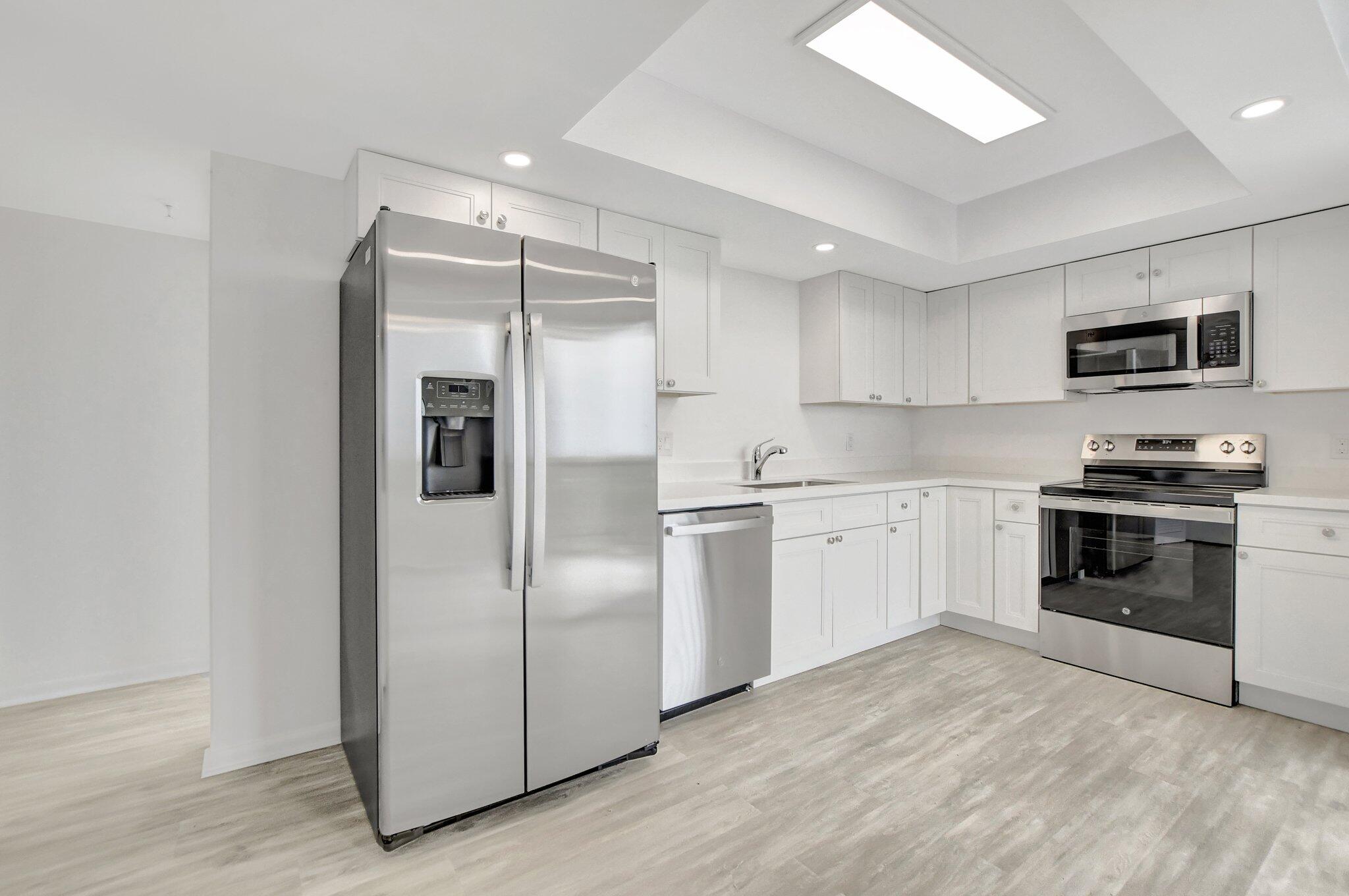 a kitchen with a refrigerator stove and microwave