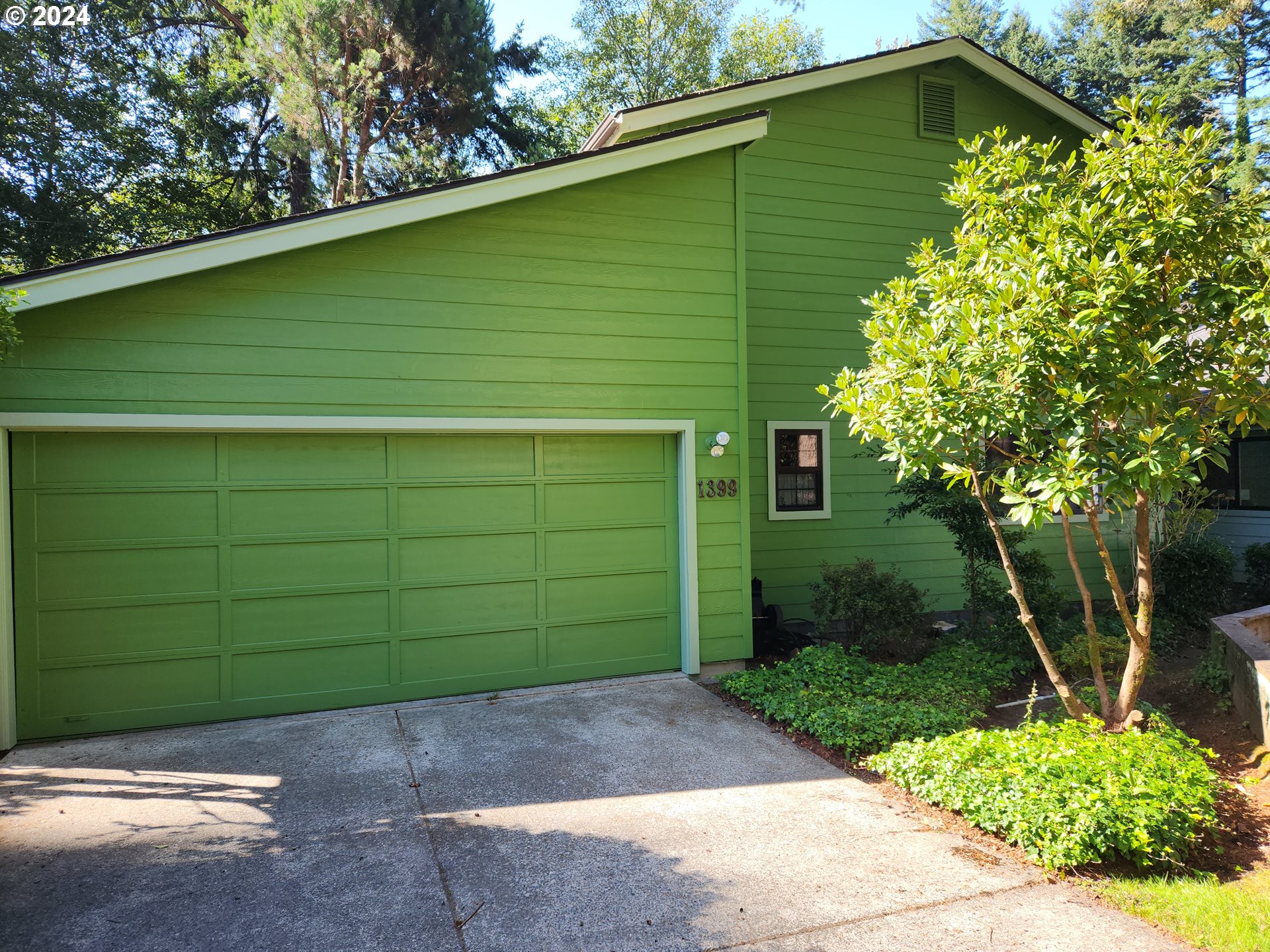 a front view of a house with a garden