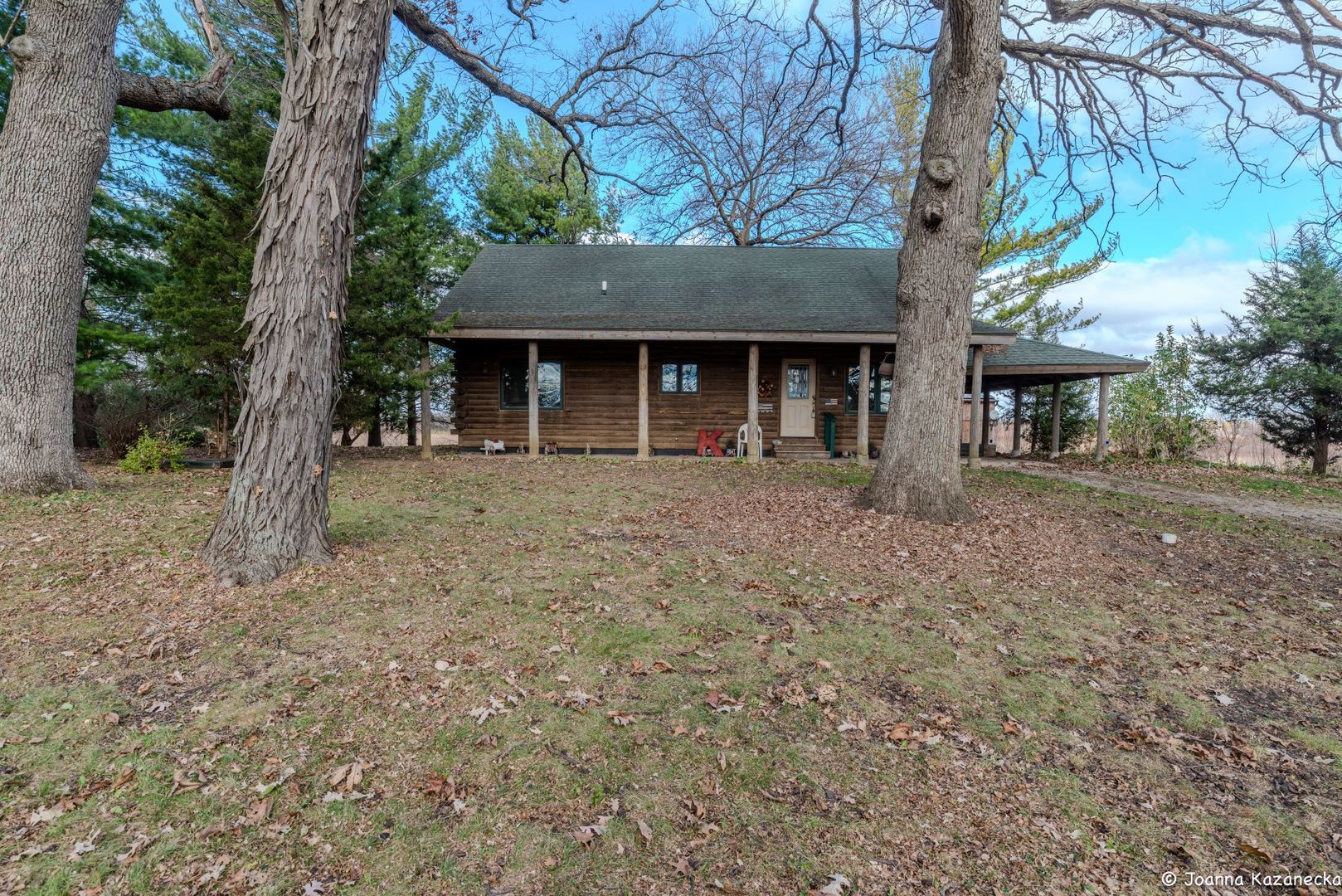 a front view of a house with a tree