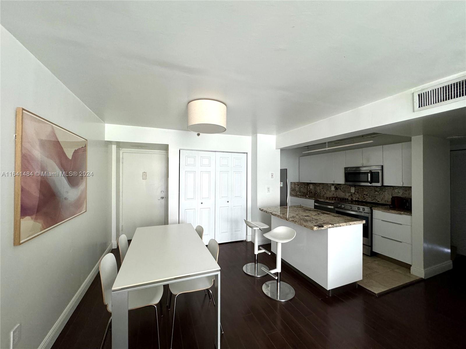 a kitchen with a table and chairs in it