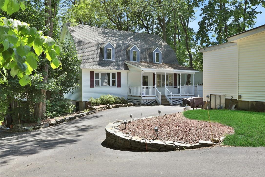 a front view of a house with a yard and trees