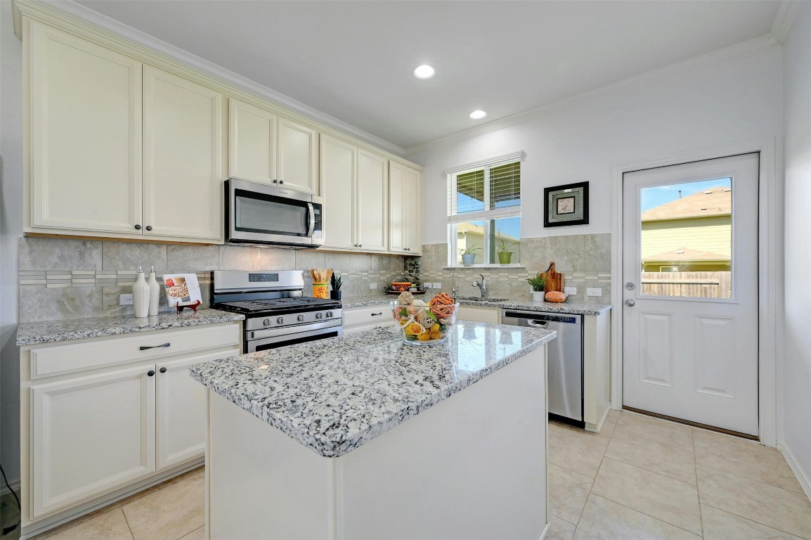 a kitchen with refrigerator and stove