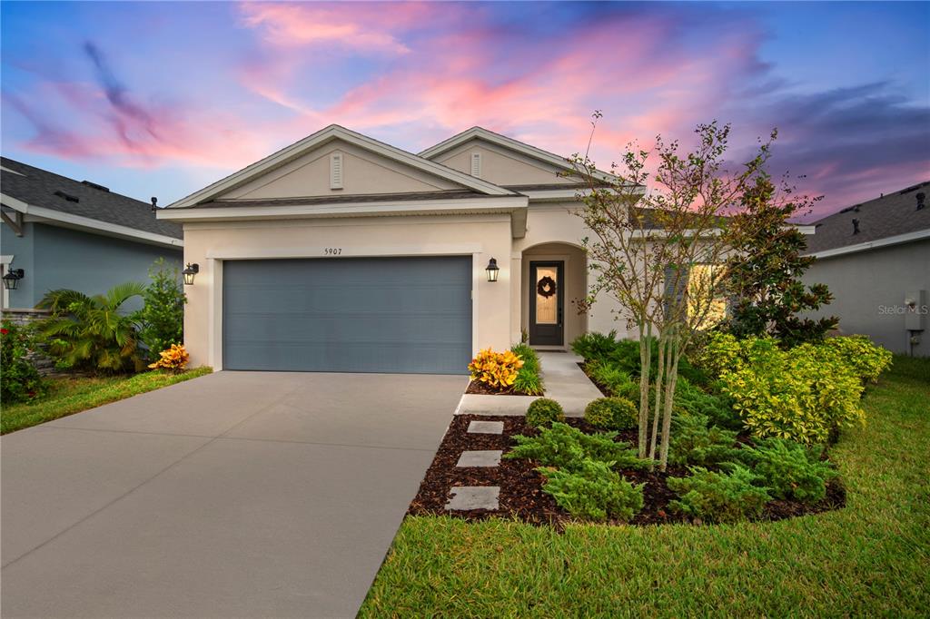 a front view of a house with a yard and garage