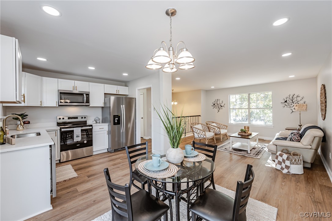 a very nice looking kitchen with furniture a large window and stainless steel appliances