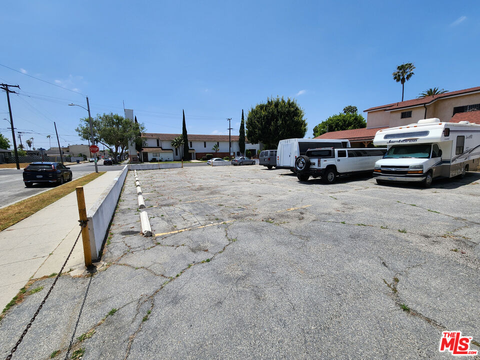 a view of a cars park in front of a building