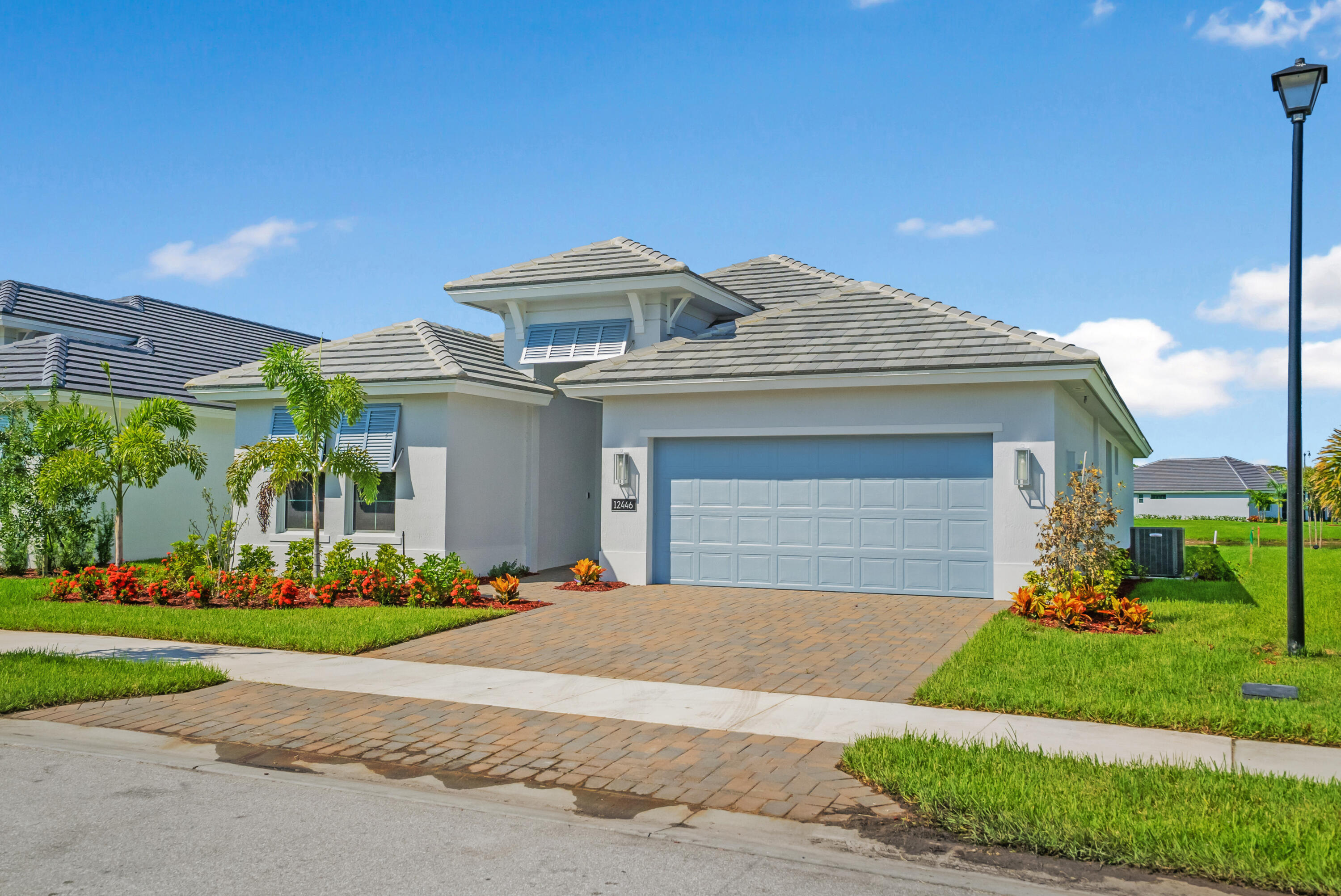 a front view of a house with a garden and plants