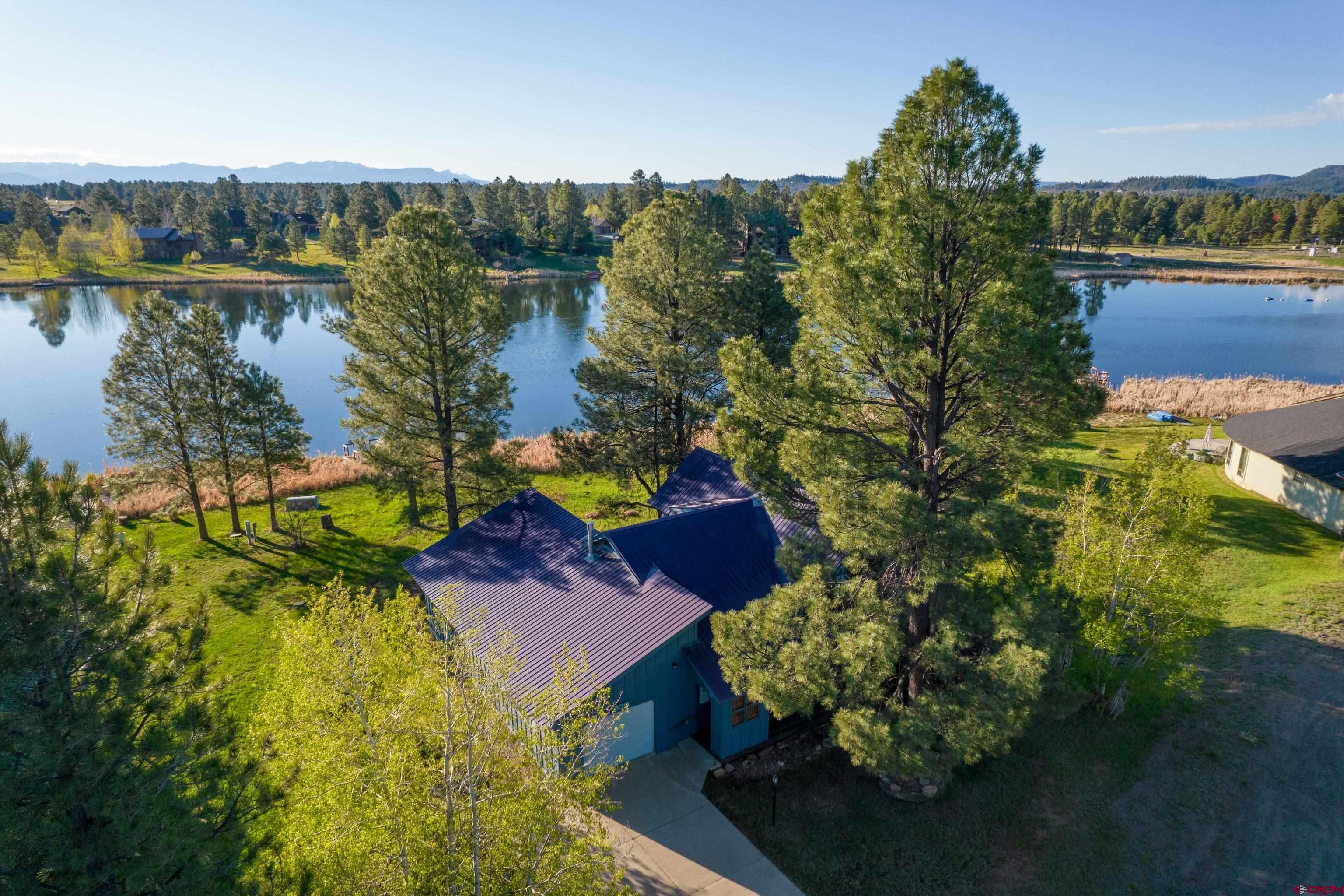 a view of a lake with a house in the background