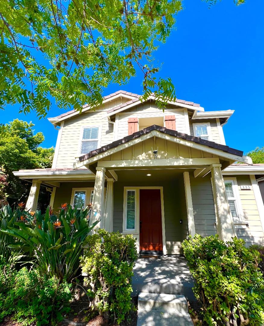 a front view of a house with plants