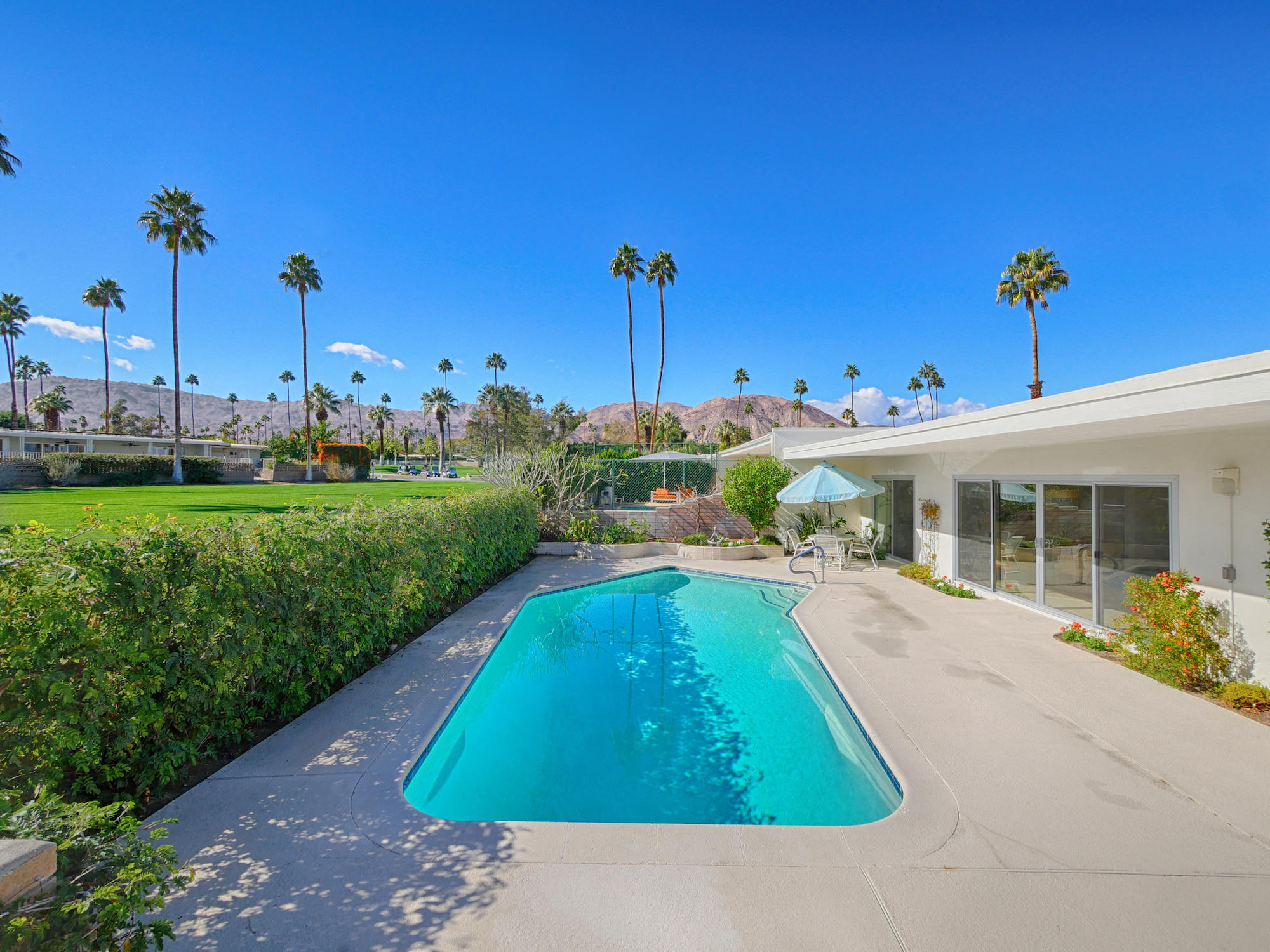 a swimming pool with outdoor seating and yard