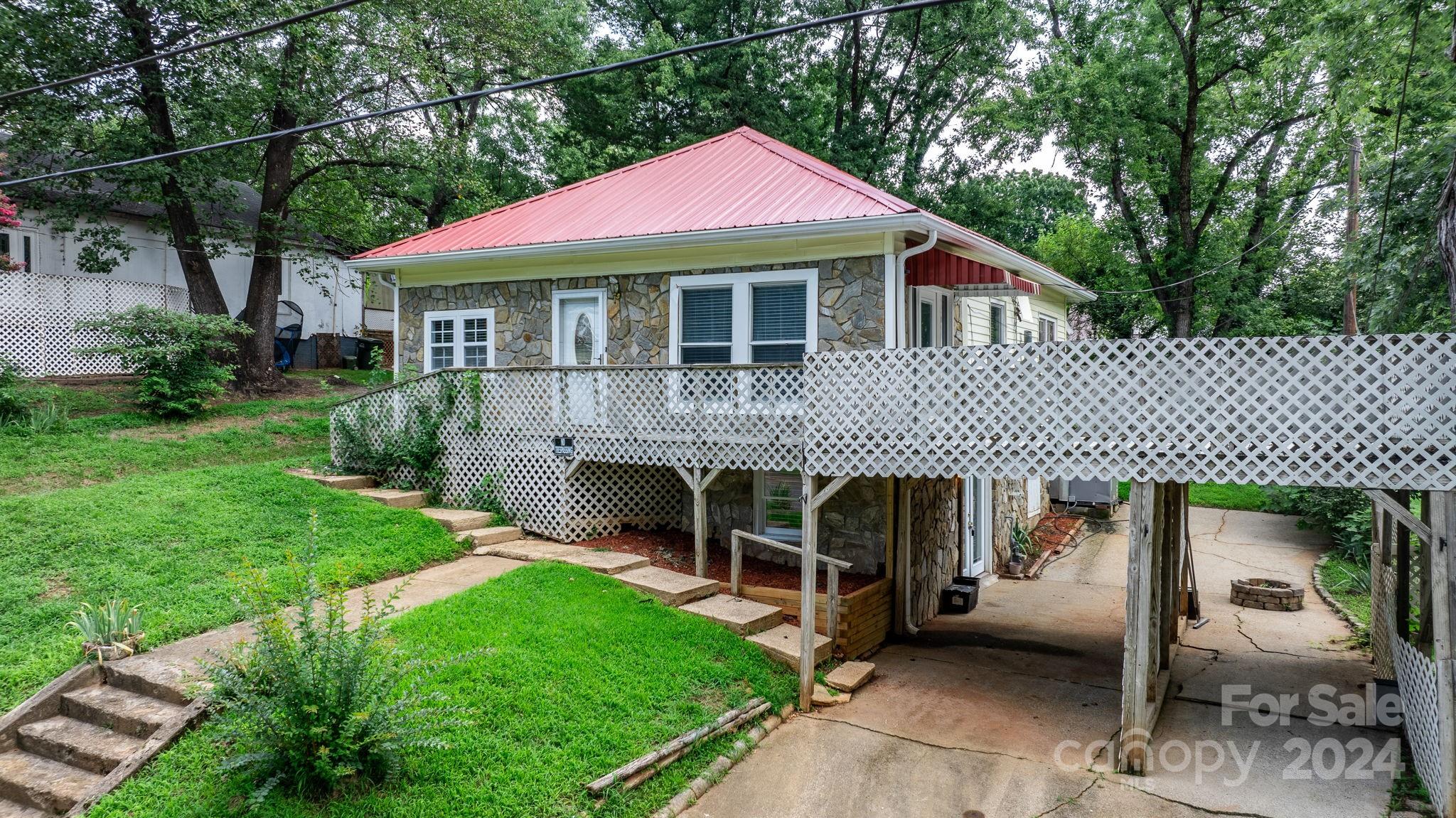 a front view of a house with a garden and plants