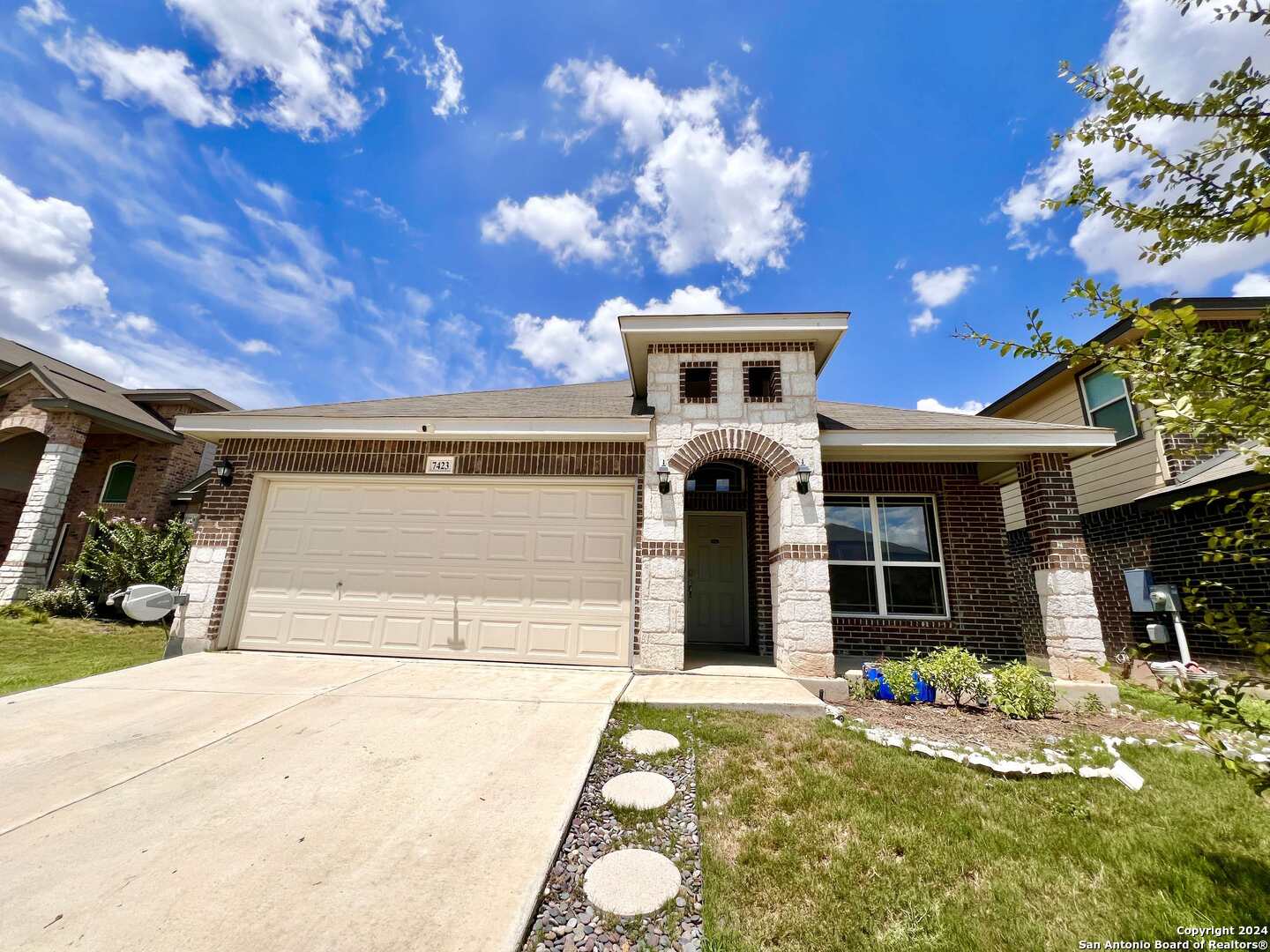 a front view of a house with a yard