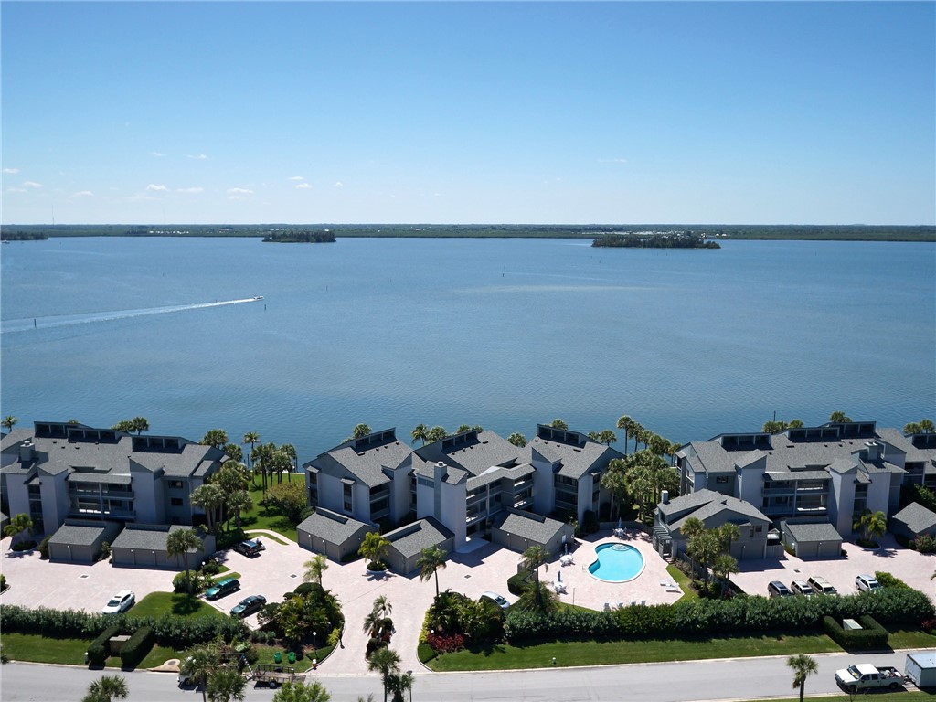 a view of a lake with lawn chairs