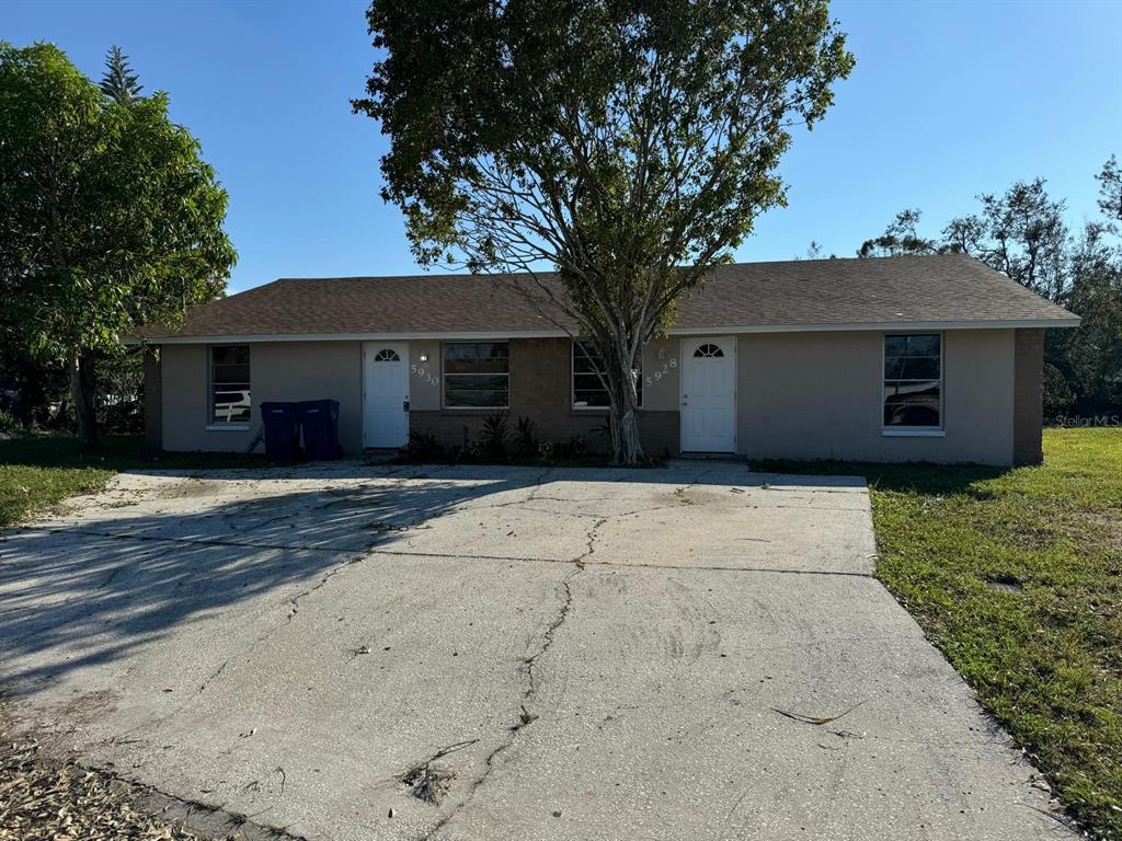 a house that has a tree in front of it